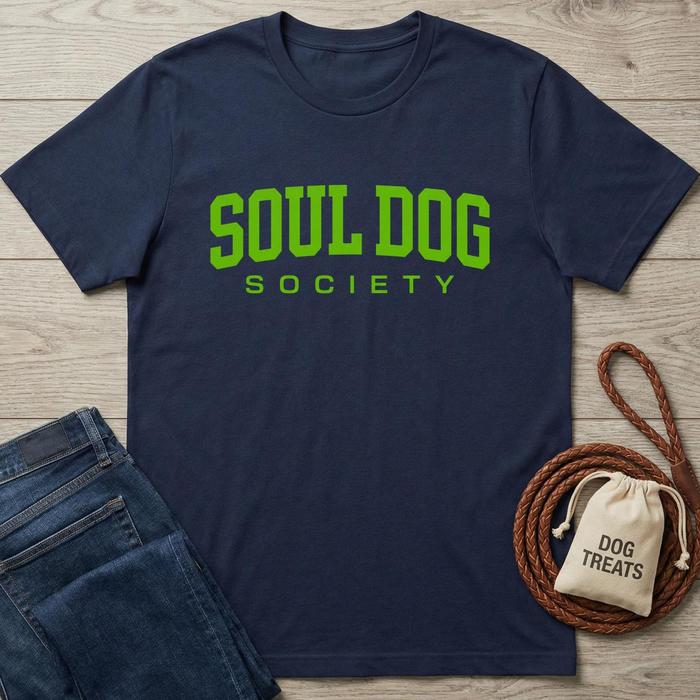 Navy blue cotton Soul Dog Society t-shirt with bright green text, next to jeans and dog treats.