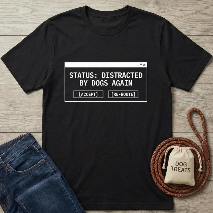 Black t-shirt with text 'Status: Distracted by Dogs Again' on a wooden surface with jeans and dog-related items.