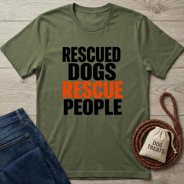 Green t-shirt with 'Rescued Dogs Rescue People' text, blue jeans, and dog treats bag on a wooden surface