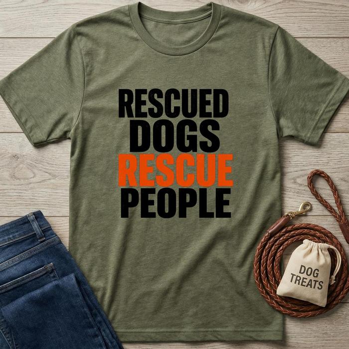 Green t-shirt with 'Rescued Dogs Rescue People' text, next to jeans and a dog treat bag on a wooden surface.