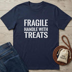 Navy blue cotton t-shirt with "FRAGILE HANDLE WITH TREATS" in white text, next to jeans and a dog treat bag.