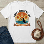 White cotton t-shirt with a vintage sunset paw print design and "My Dog Rescued Me" text.