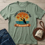 Sage green "My Dog Rescued Me" t-shirt with a vintage sunset paw print design and black dog silhouette.