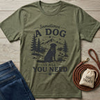 Olive green "Sometimes A Dog Is All You Need" tee with a black dog graphic, beside jeans and a leash.