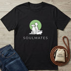 Black Gildan Softstyle® cotton tee with a green "Soulmates" dog and person design, next to jeans and dog treats.