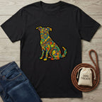 Black "Love In Color" t-shirt with a vibrant, colorful, psychedelic dog design, next to jeans and dog treats.