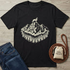 Black cotton t-shirt with a cream graphic of a dog on a mountain peak surrounded by pine trees.