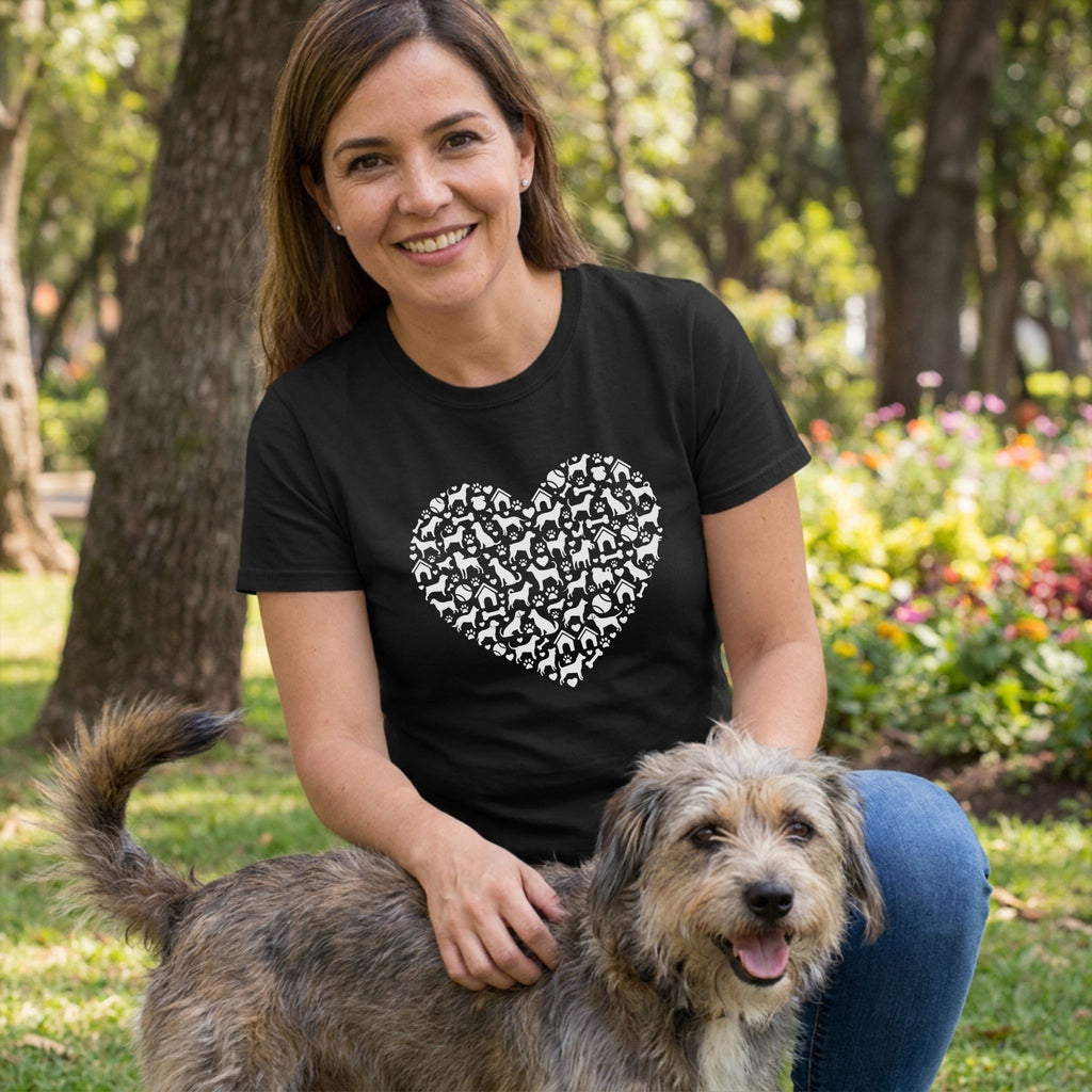 Woman in black "Heart For Dogs" t-shirt with white canine silhouettes, petting a dog outdoors.