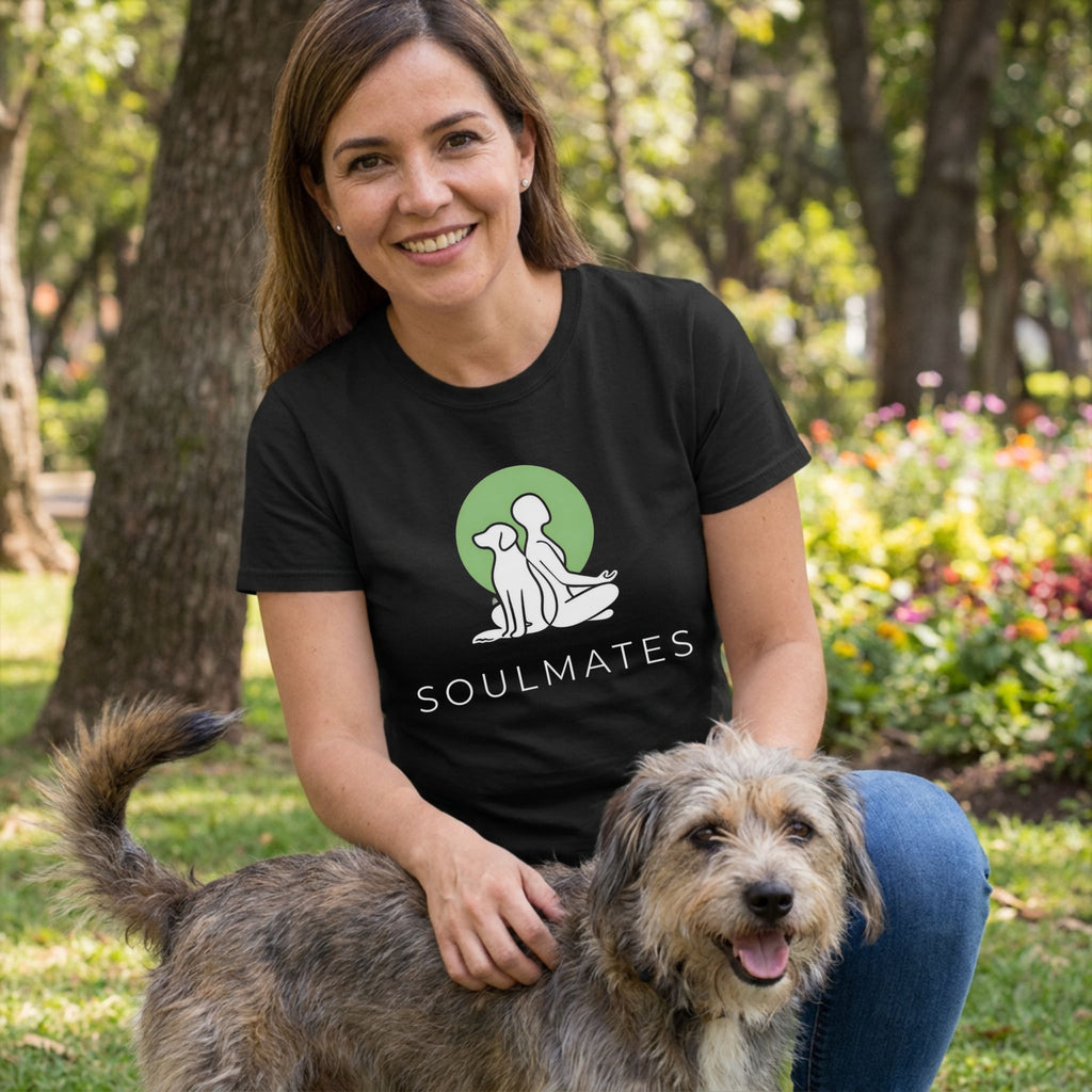Woman in black "Soulmates" tee with dog and person design, petting a rescue dog outdoors.