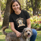 Woman in black "Old Dogs Are The Best Kind of Magic" t-shirt with a golden retriever graphic, petting a dog.