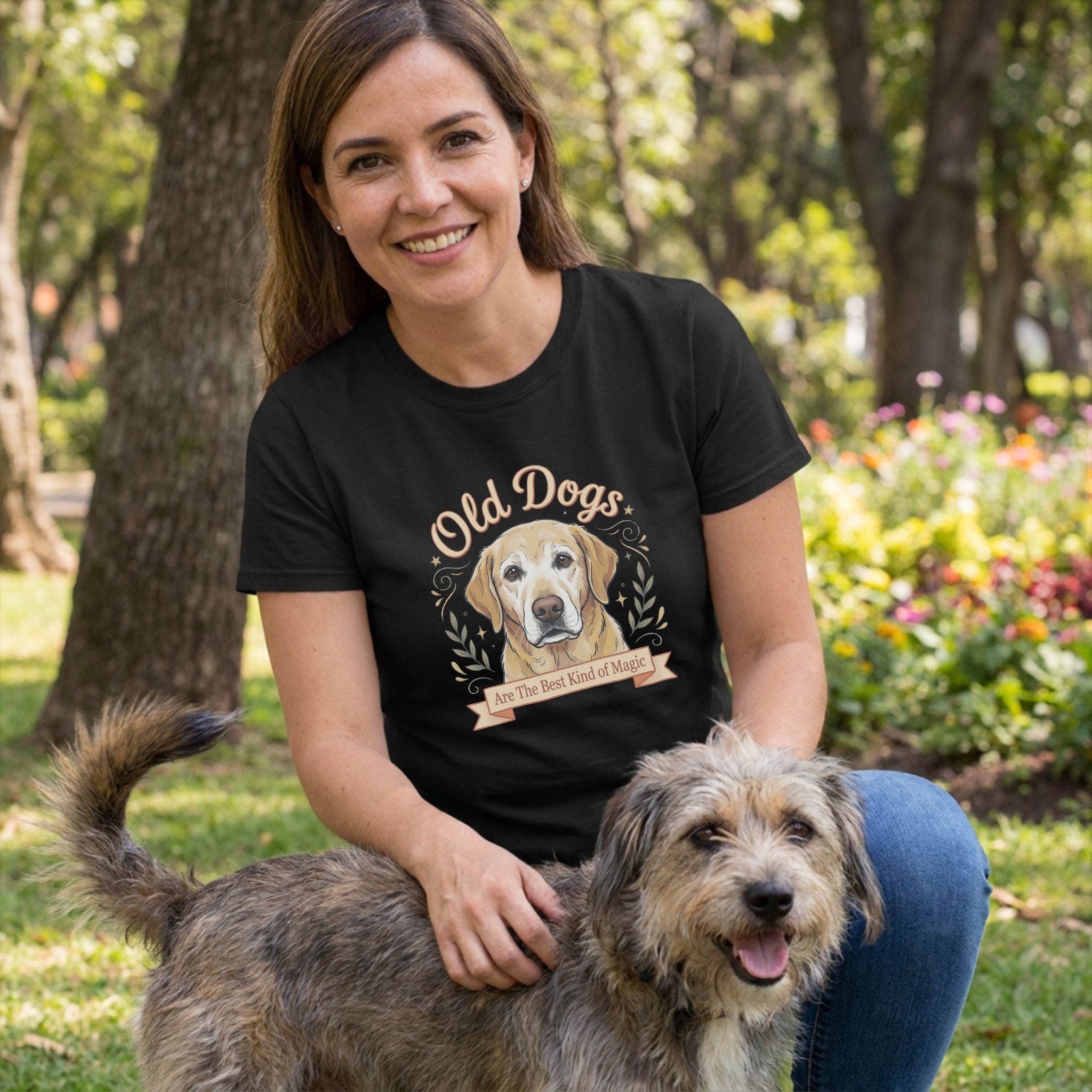 Woman in black "Old Dogs Are The Best Kind of Magic" t-shirt with a golden retriever graphic, petting a dog.