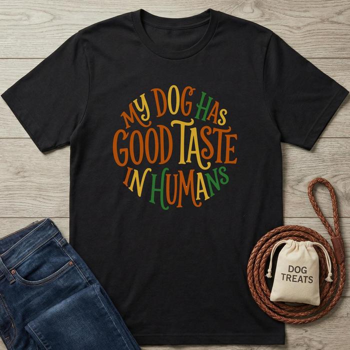 Black cotton t-shirt with "My Dog Has Good Taste In Humans" in colorful, circular text.
