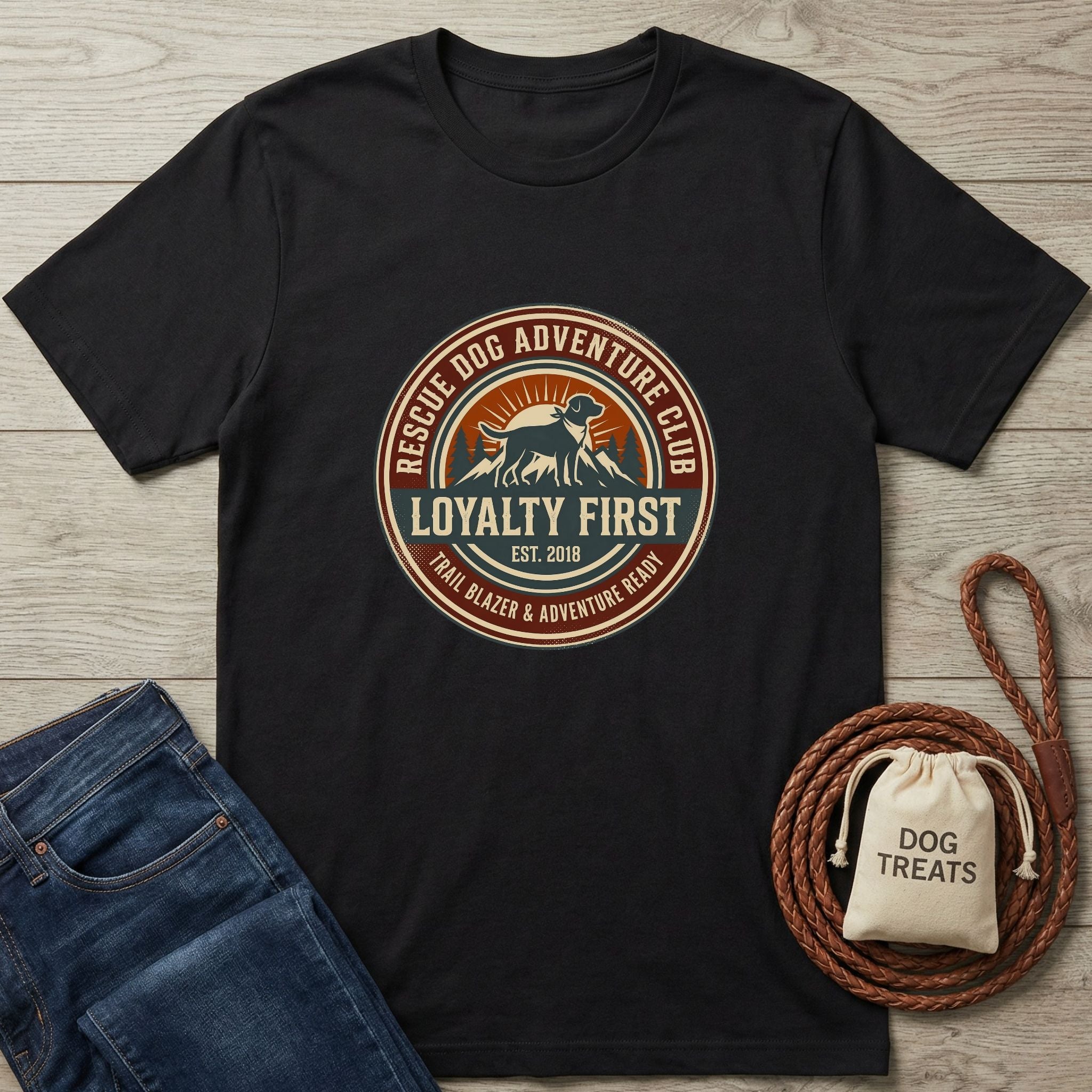 Black Gildan Softstyle t-shirt with "Rescue Dog Adventure Club" graphic, jeans, and dog treats.