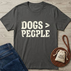 Charcoal grey Gildan Softstyle t-shirt with "DOGS > PEOPLE" in distressed white text, next to blue jeans and dog treats.