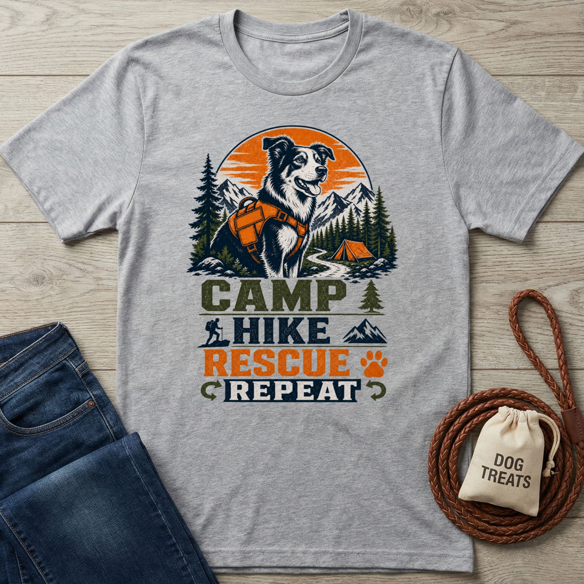 Grey crewneck t-shirt featuring a graphic of a dog in a harness with mountains, a tent, and Camp Hike Rescue Repeat text.