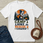 White t-shirt featuring a graphic of a dog in a hiking harness with mountain, forest, and campfire print.