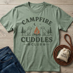 Sage green crewneck t-shirt featuring a campfire and dog graphic with Campfire Cuddles Club text.