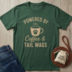 Dark green t-shirt with "Powered by Coffee & Tail Wags" design featuring a paw print coffee mug.