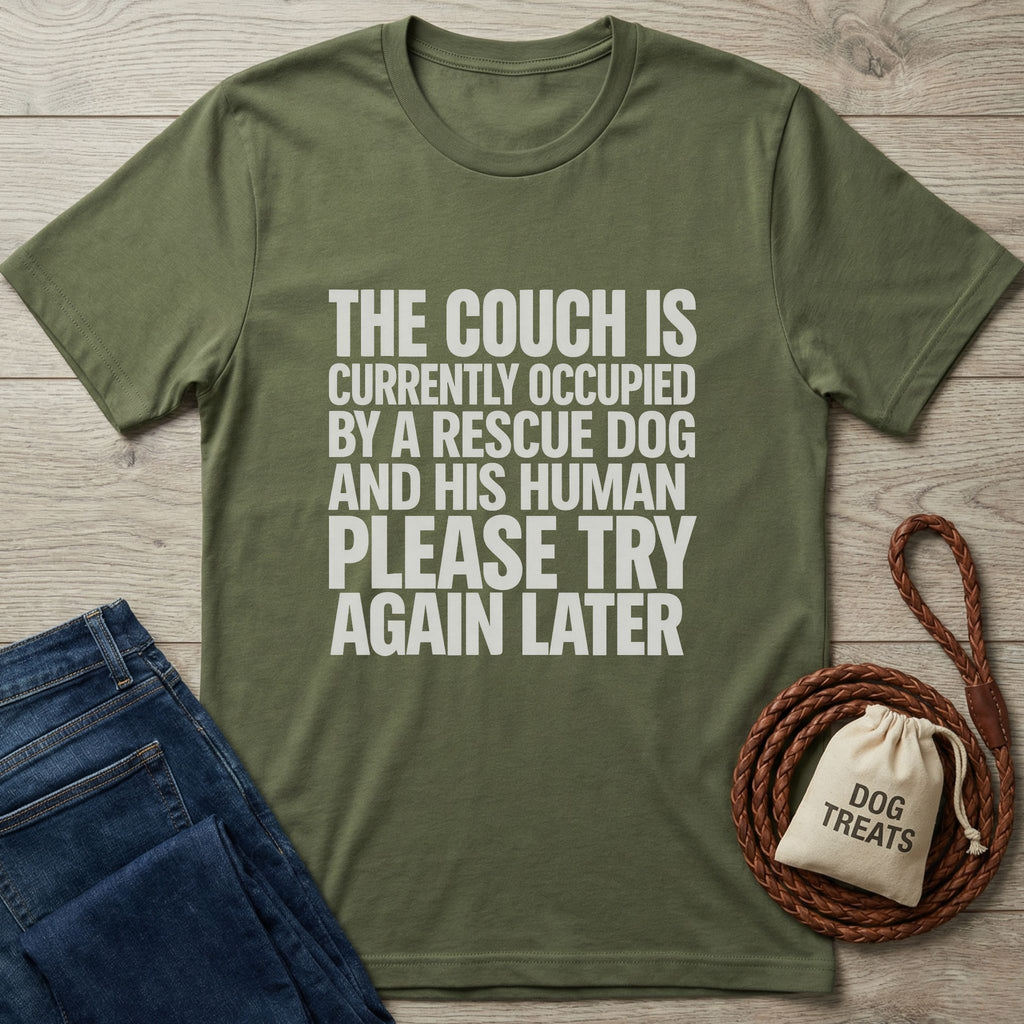 Olive green Gildan Softstyle t-shirt with "THE COUCH IS CURRENTLY OCCUPIED BY A RESCUE DOG AND HIS HUMAN PLEASE TRY AGAIN LATER" text.