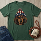 Forest green t-shirt with a vintage-style dachshund wearing a red, white, and blue stars and stripes pom-pom hat.