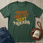Forest green cotton t-shirt with "Dogs Are My Best Friends" text, next to folded jeans and dog treats.