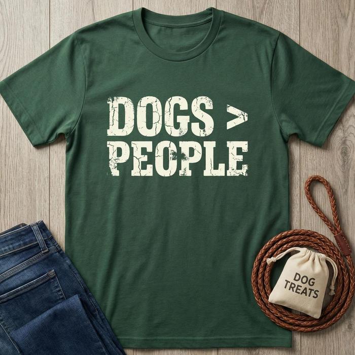 Dark green cotton t-shirt with "DOGS > PEOPLE" in distressed white text, next to jeans and dog treats.