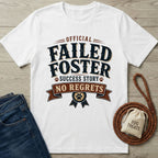 White "Official Failed Foster Success Story No Regrets" t-shirt with dog paw details, next to jeans and dog treats.