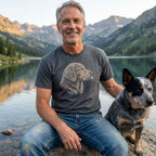Gray Favorite Bone T-shirt with a sketch-style dog portrait, worn by a man next to a blue heeler.