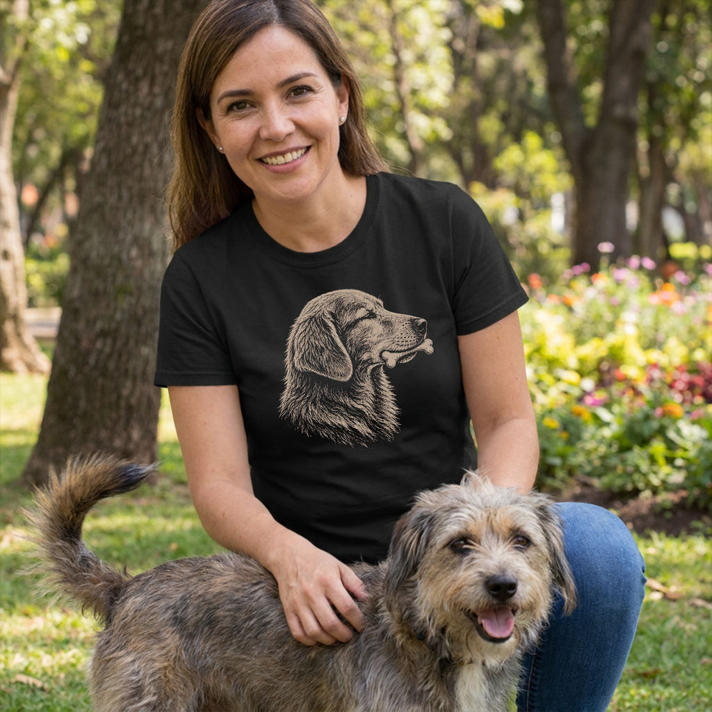 Woman in black t-shirt with sketch-style dog and bone graphic, petting a scruffy dog outdoors.