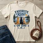 Cream-colored crewneck t-shirt featuring a graphic of three dogs sitting on a dock by a lake with vintage-style typography.