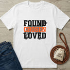 White Gildan Softstyle t-shirt with "FOUND CHOSEN LOVED" text and a dog silhouette, beside jeans and a leash.