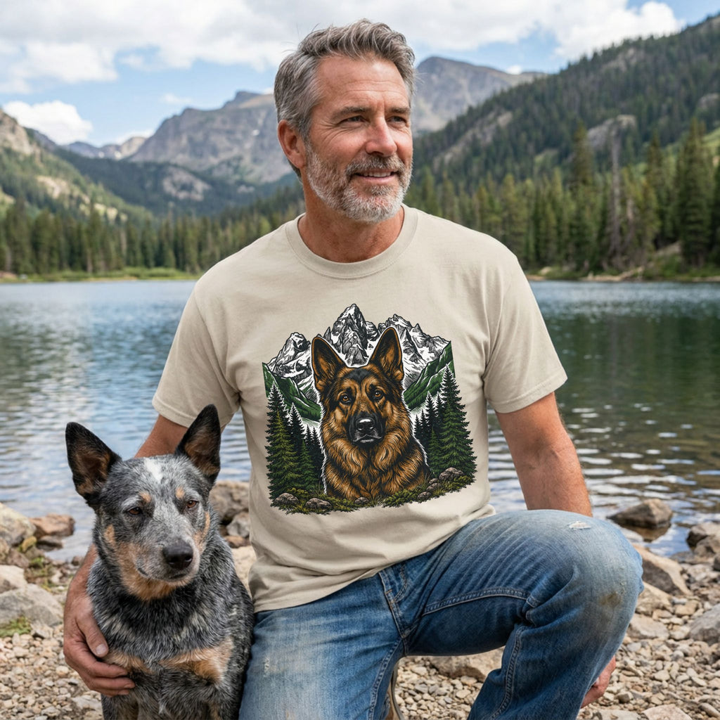 Man wearing a beige crewneck t-shirt featuring a detailed German Shepherd portrait with mountain and pine forest graphics.