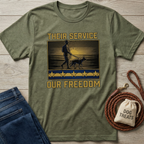Olive green "Their Service Our Freedom" t-shirt with soldier and K9 graphic, gold stars, and text.