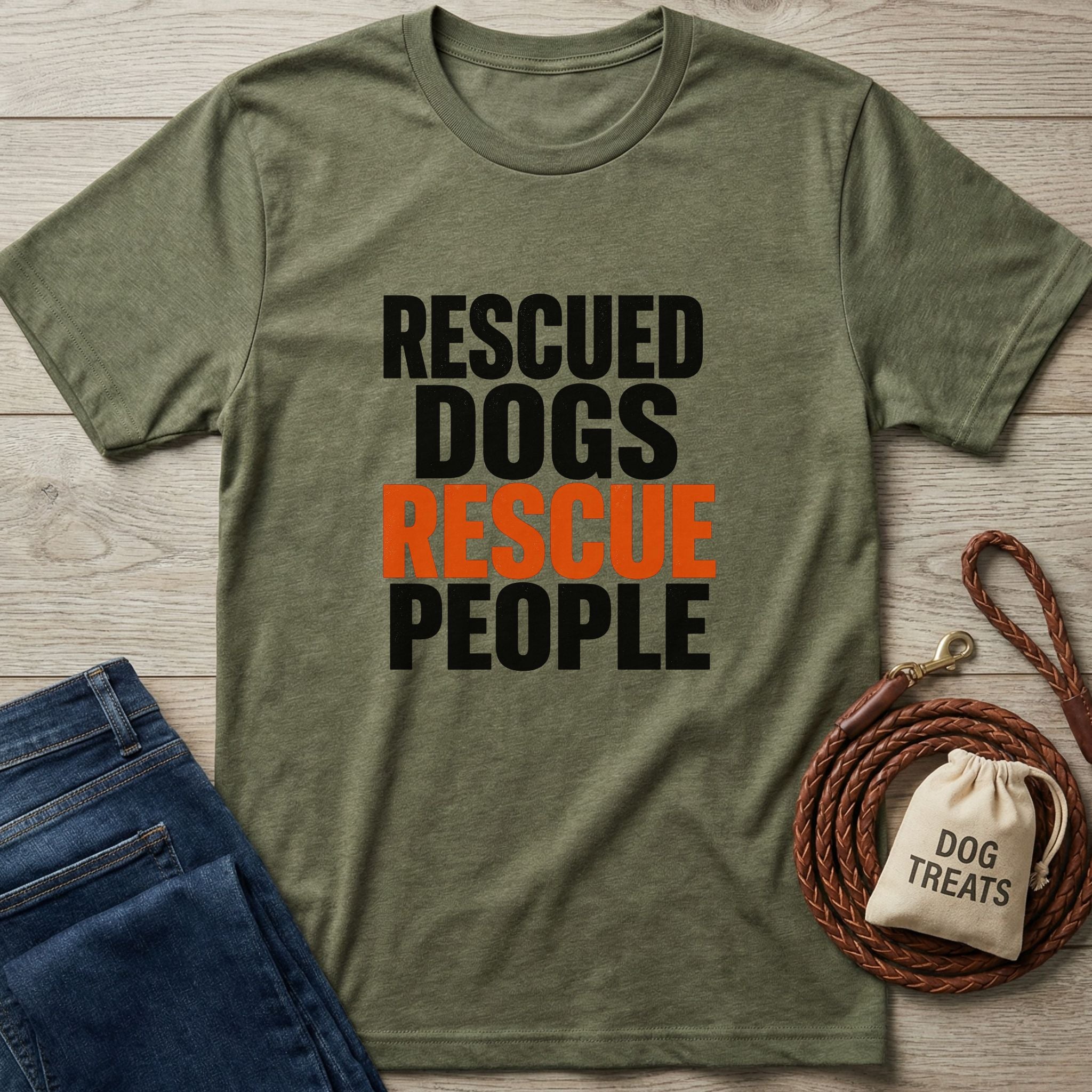 Olive green Gildan Softstyle t-shirt with "RESCUED DOGS RESCUE PEOPLE" text, alongside jeans and dog leash.