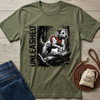 Olive green Unleashed T-shirt with a graphic of a dog in an orange harness jumping over a log.