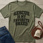 Olive green "Rescue Is My Favorite Breed" t-shirt with jeans, a coiled leather leash, and a "Dog Treats" bag.