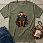 Olive green tee with vintage patriotic dachshund wearing a stars and stripes pom-pom hat.