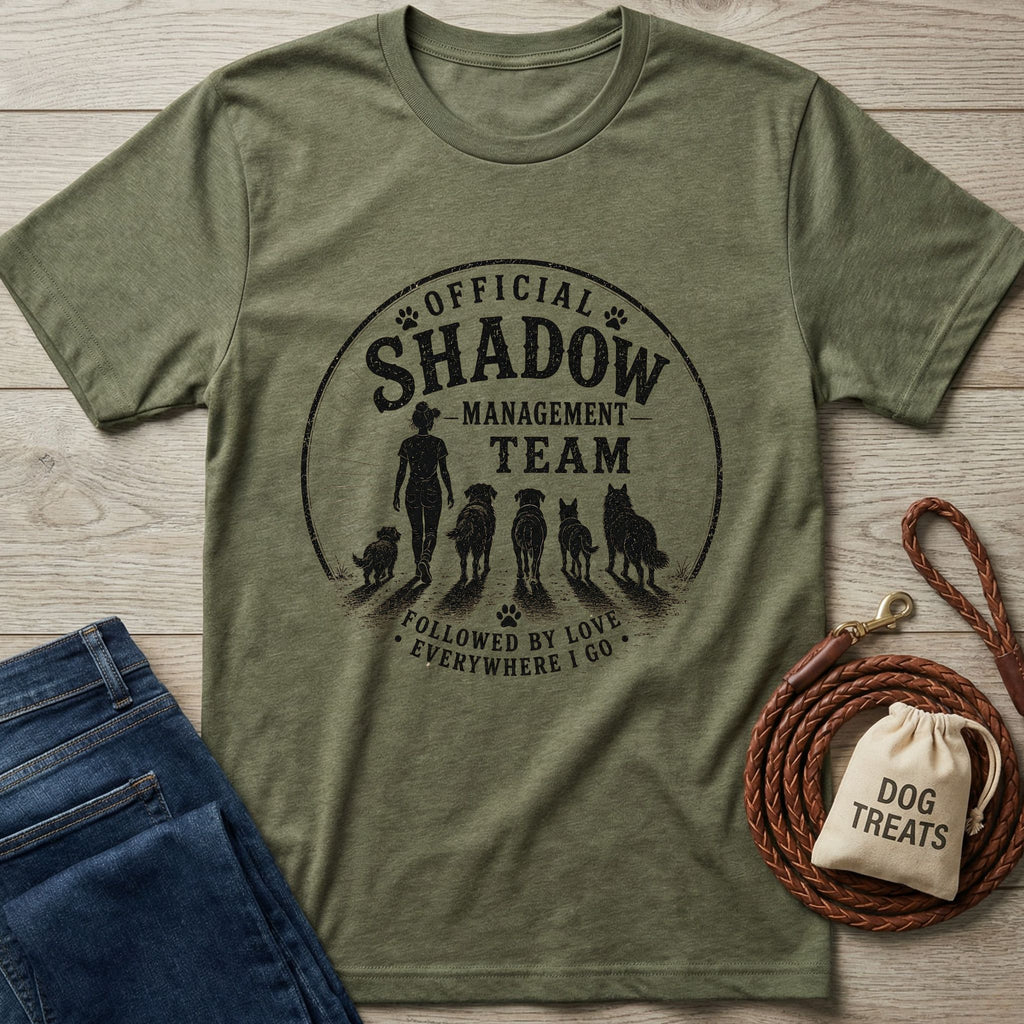 Olive green heather t-shirt with "Official Shadow Management Team" graphic featuring a person and five dogs.