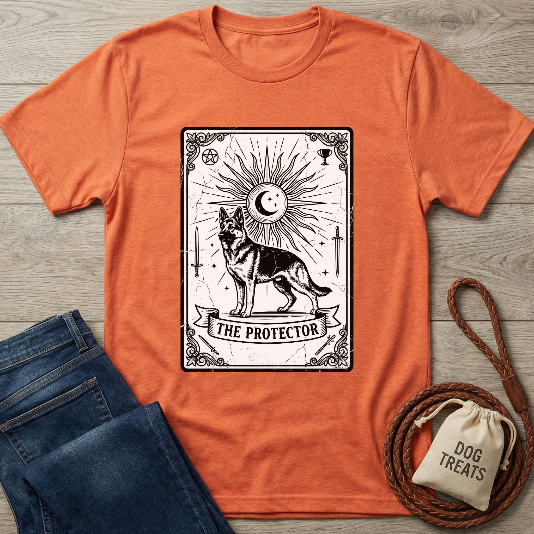 Orange cotton t-shirt with "The Protector" tarot card design featuring a German Shepherd, sun, and moon.