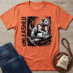 Orange "Unleashed" T-shirt with a jumping dog graphic, paired with jeans and dog treats.