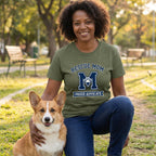 Woman in olive green "Rescue Mom Proud Advocate" tee with a Corgi.