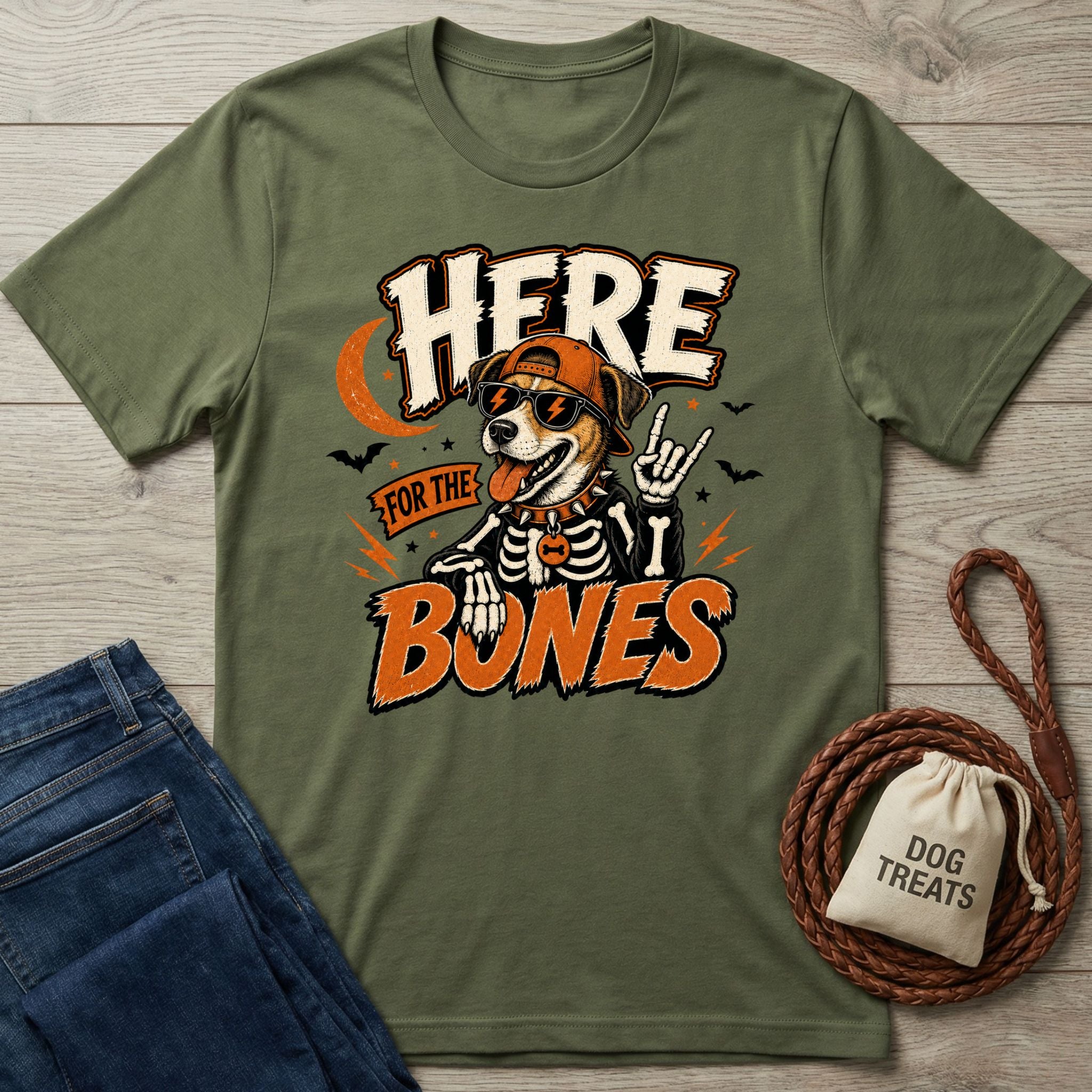 Olive green crewneck t-shirt featuring a rockstar dog in a skeleton costume, sunglasses, and cap with Here For The Bones text.