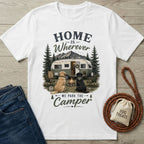 White crew neck t-shirt featuring a vintage camper, campfire, and two dogs with the text Home Is Wherever We Park The Camper.