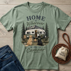 Sage green crewneck t-shirt featuring a vintage camper, campfire, and two dogs with the text Home Is Wherever We Park The Camper.