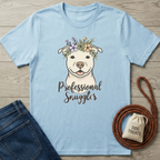 Light blue cotton t-shirt with a smiling pit bull wearing a floral crown and "Professional Snuggler" text.
