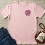 Pink Gildan Softstyle® 64000 tee with a colorful paw print design on the left chest.
