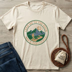 Cream Gildan Softstyle® t-shirt with "Lead Me To The Rock And A Rescue Dog" graphic, jeans, and dog treats bag.