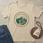 Beige Gildan Softstyle t-shirt with "Lead Me To The Rock And A Rescue Dog" graphic, jeans, and dog treats.