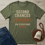 Olive green crewneck t-shirt featuring Second Chances Look Good on Everyone text and a paw print heart design.