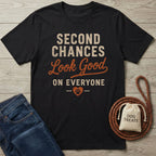 Black cotton t-shirt featuring distressed text reading Second Chances Look Good On Everyone with a paw print heart.